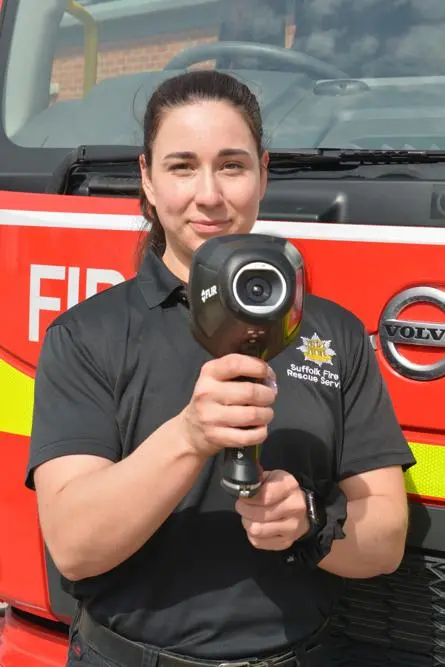 Firefighter holding a thermal imaging camera