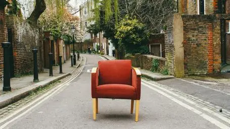 A red armchair abandoned in the street