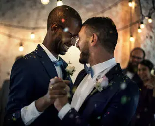 Two men dancing at their wedding. 