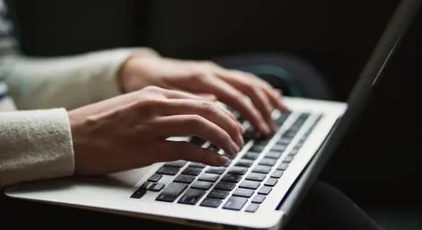Woman typing on laptop