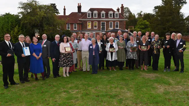 A group of people standing holding awards for the Suffolk Community Awards
