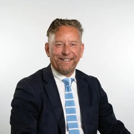 Councillor Adrian Whittle wearing suit and tie