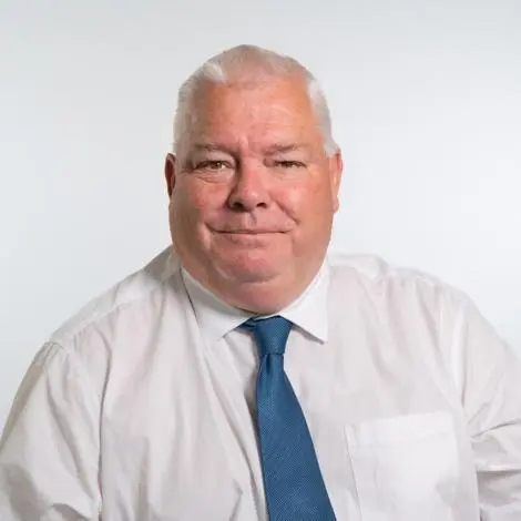 Cllr Andrew Burton wearing white shirt and blue tie