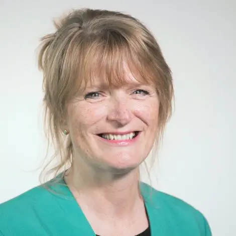 Image of Councillor Dunning wearing a green jacket and black top