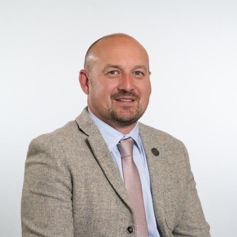 Cllr Asa Downing wearing beige jacket, light blue shirt and pink tie