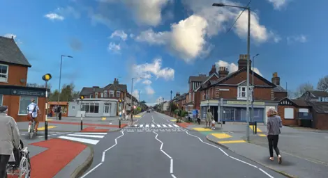 A high street with several people walking along the path