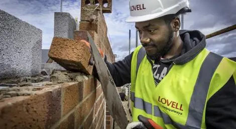 Making laying a brick on a wall.