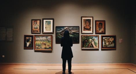 Person standing in front of artworks in an art gallery