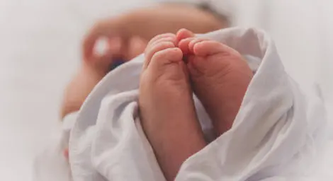 Feet of a new born baby wrapped up
