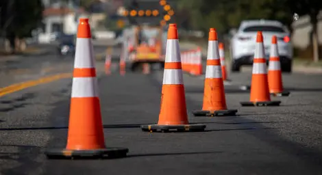 Orange traffic cones stand on a road