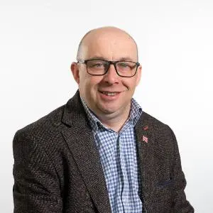 Councillor Stuart Allen wearing brown jacket and blue checked shirt