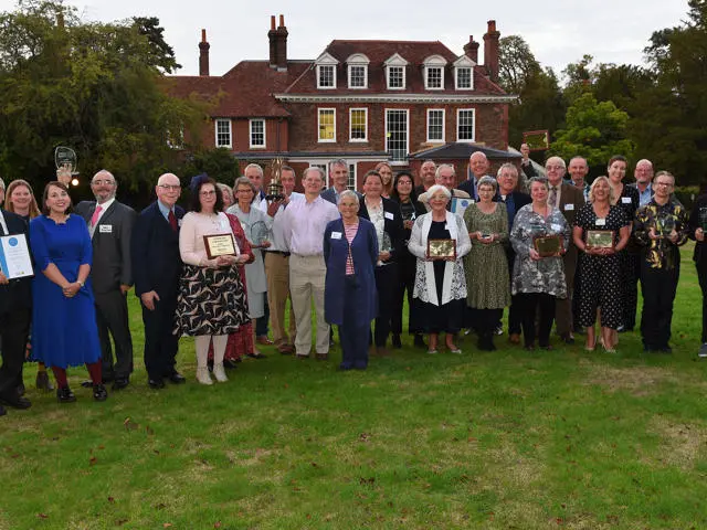 A group of people standing holding awards for the Suffolk Community Awards